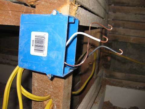 A brand new junction box with the hot (black), neutral (white), & ground (copper) wires all ready to go!