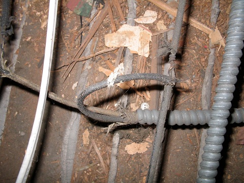 All splices MUST be in junction boxes. Touching that bare wire would be shocking...