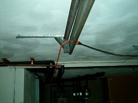 Extension cords should never be used as a permanent way to electrify anything...no, not even your garage door.